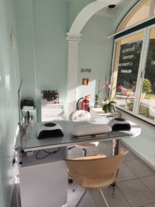 salon interior, featuring a manicure table and supplies