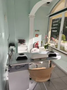 salon interior, featuring a manicure table and supplies